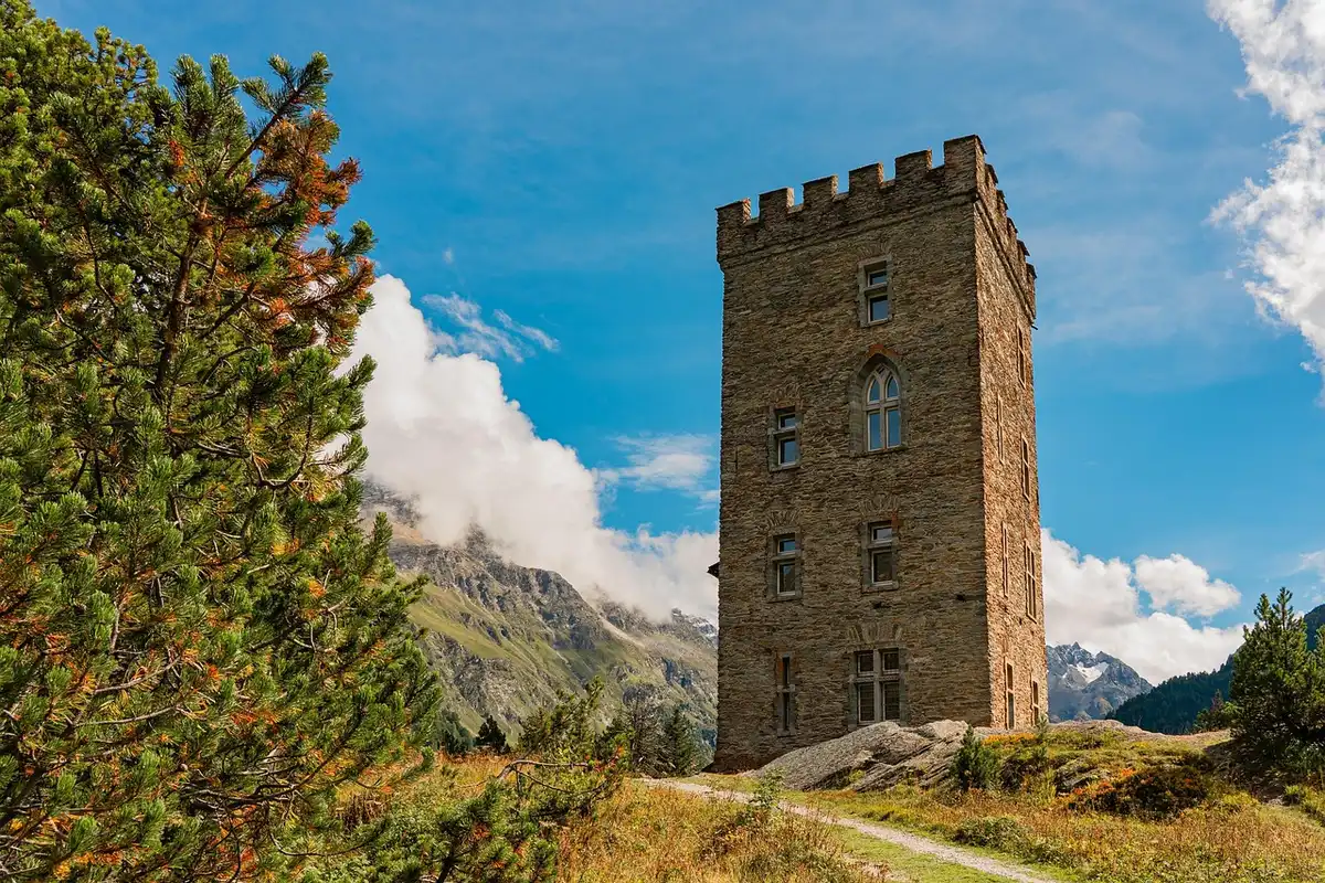 Ruinas de castillo medieval en paisaje árido con colinas al fondo